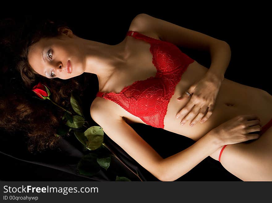 Beautiful girl in red lingerie with red rose. Beautiful girl in red lingerie with red rose