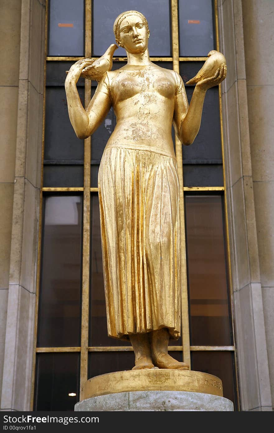 Golden statue of a woman next to eiffel tower in paris. Golden statue of a woman next to eiffel tower in paris