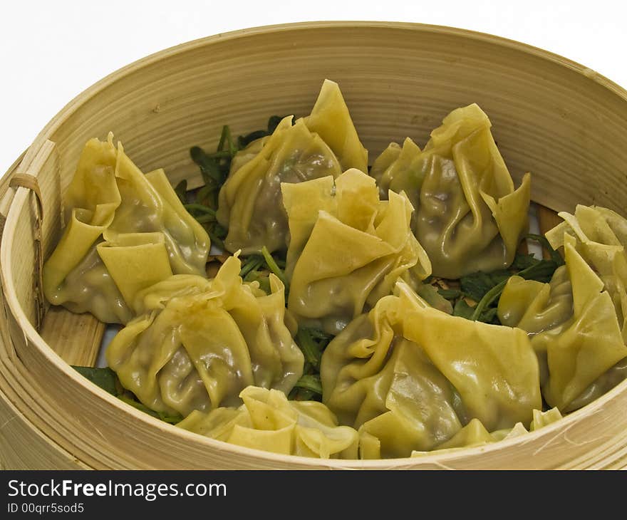 Chinese steamed dumplings in a bamboo basket. Chinese steamed dumplings in a bamboo basket