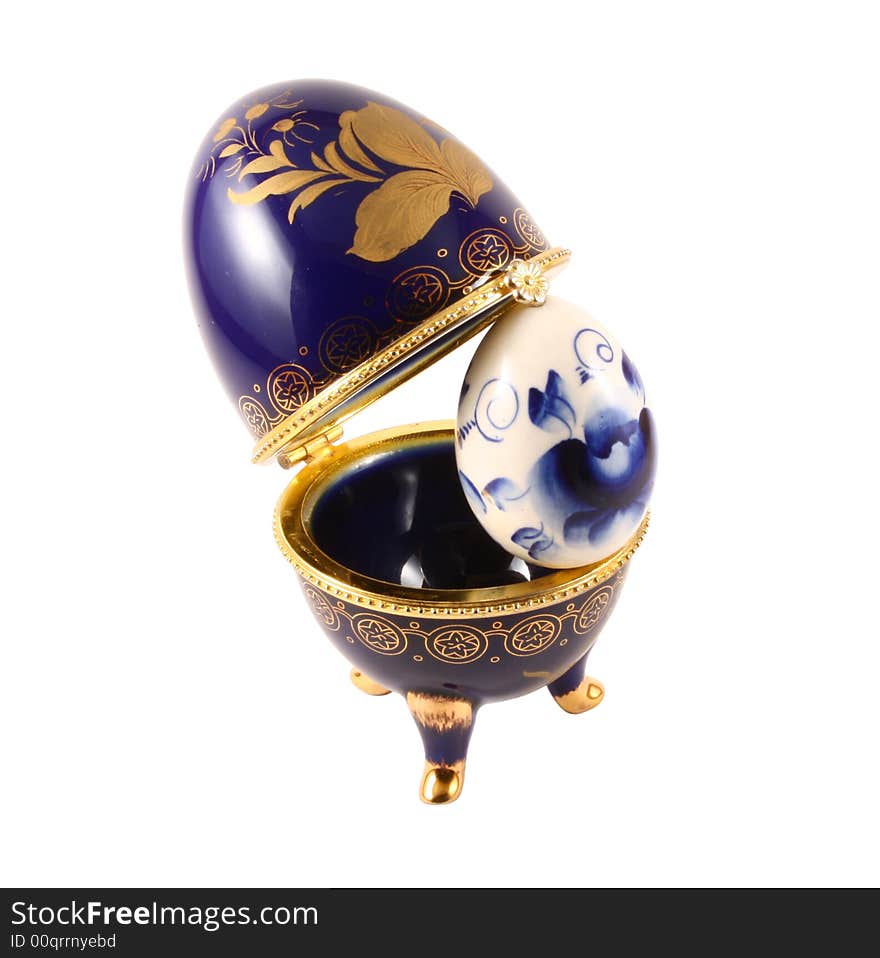 Dark blue easter egg in a gold small box on a white background