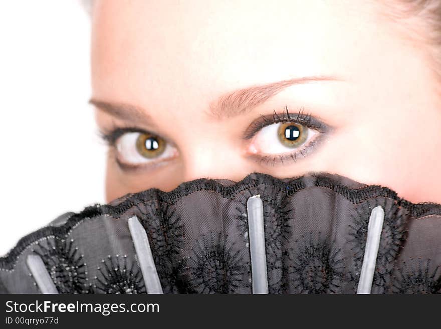 Portrait of a cute brunette with black fan over white. Portrait of a cute brunette with black fan over white