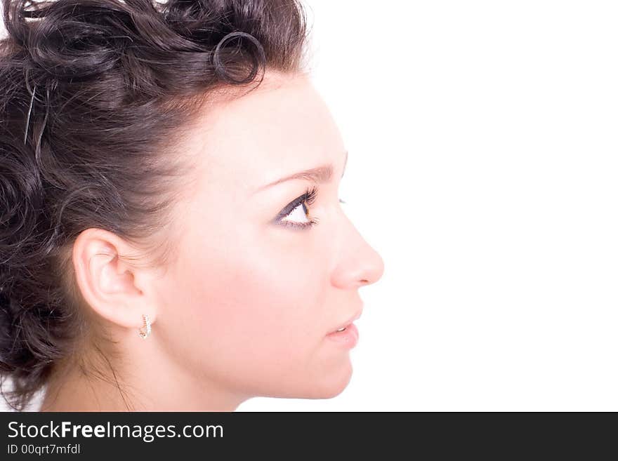 Beautiful brunette looks up on white background