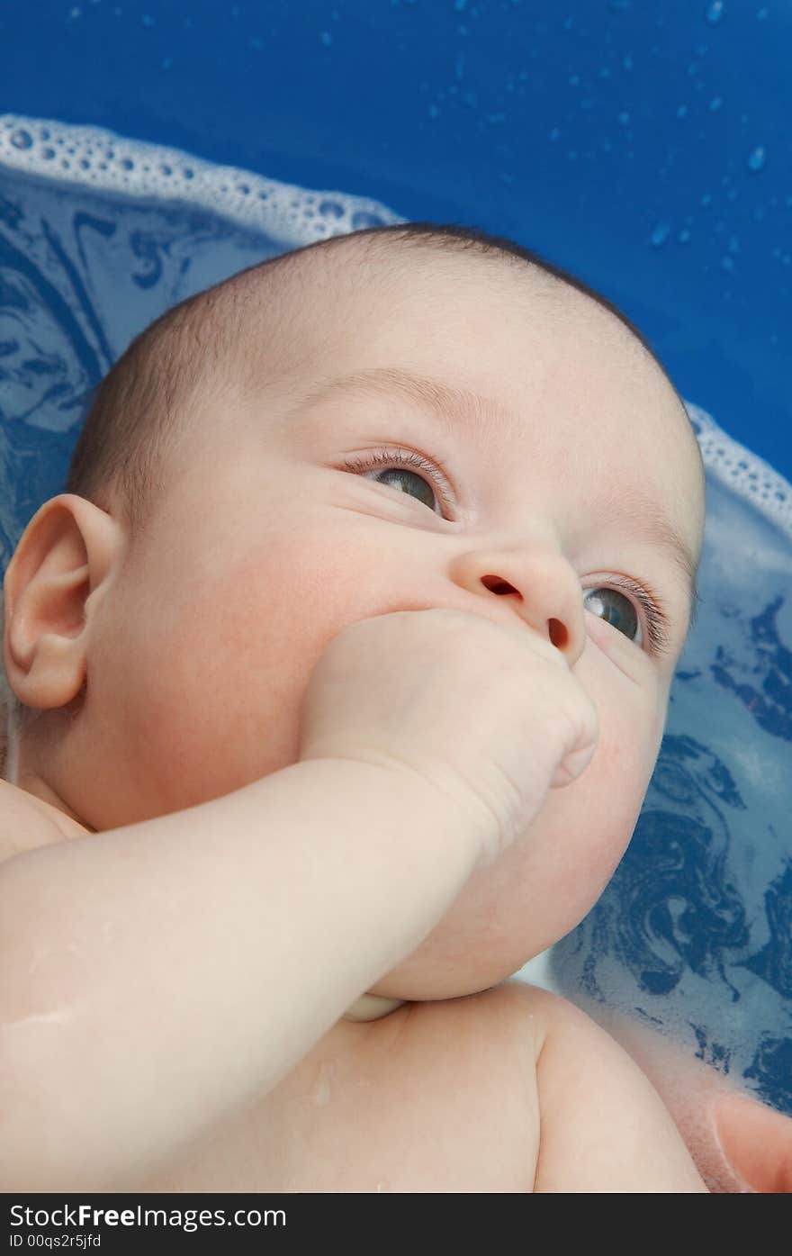 Baby boy having his first bath at home