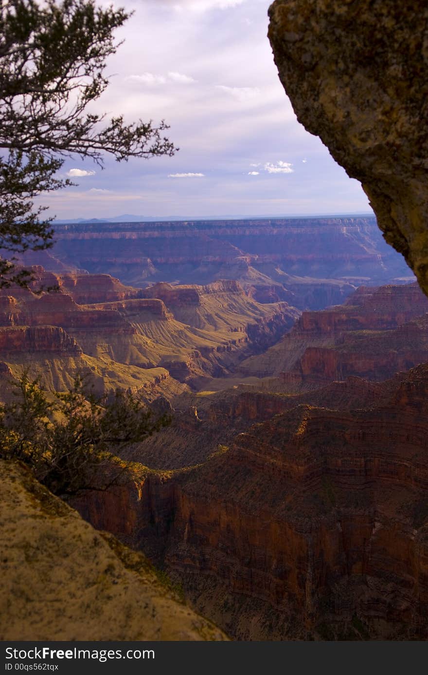 A view of Bright Angel Canyon framed by the rocks and trees at the North Rim of the Grand Canyon. A view of Bright Angel Canyon framed by the rocks and trees at the North Rim of the Grand Canyon.