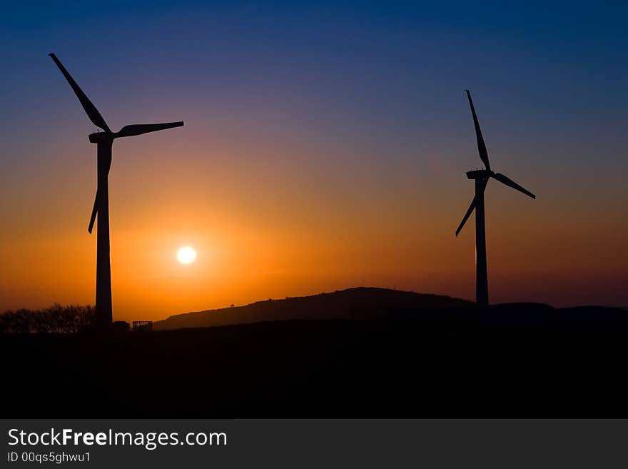 Sunset with two windmills in win farm. Sunset with two windmills in win farm