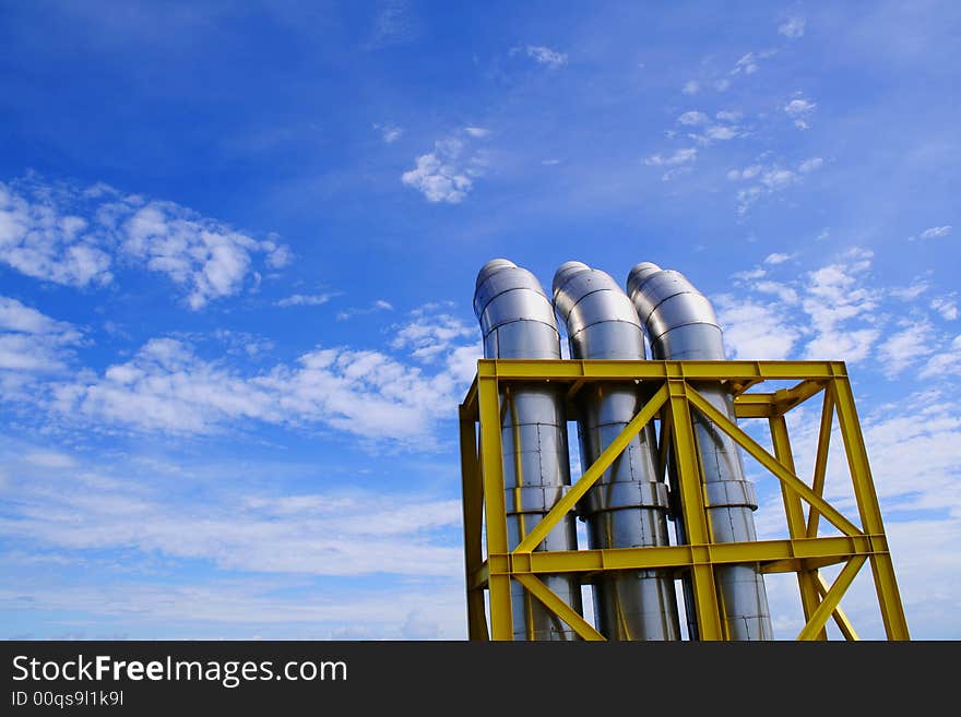 Exhausts under a blue sky with some clouds. Exhausts under a blue sky with some clouds