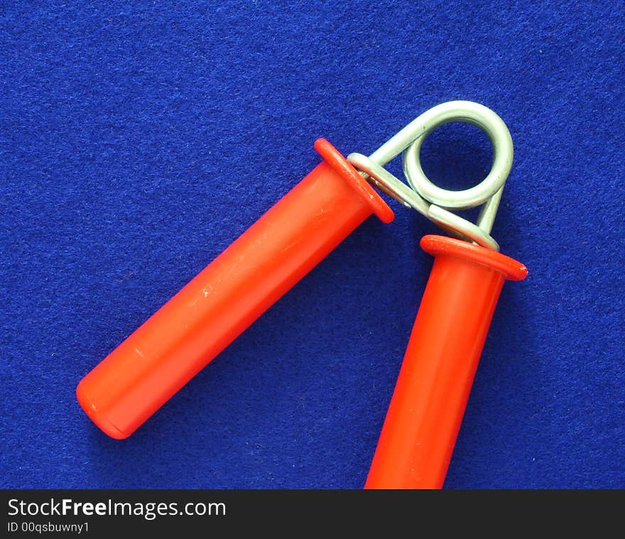 Red hand exerciser over a blue background