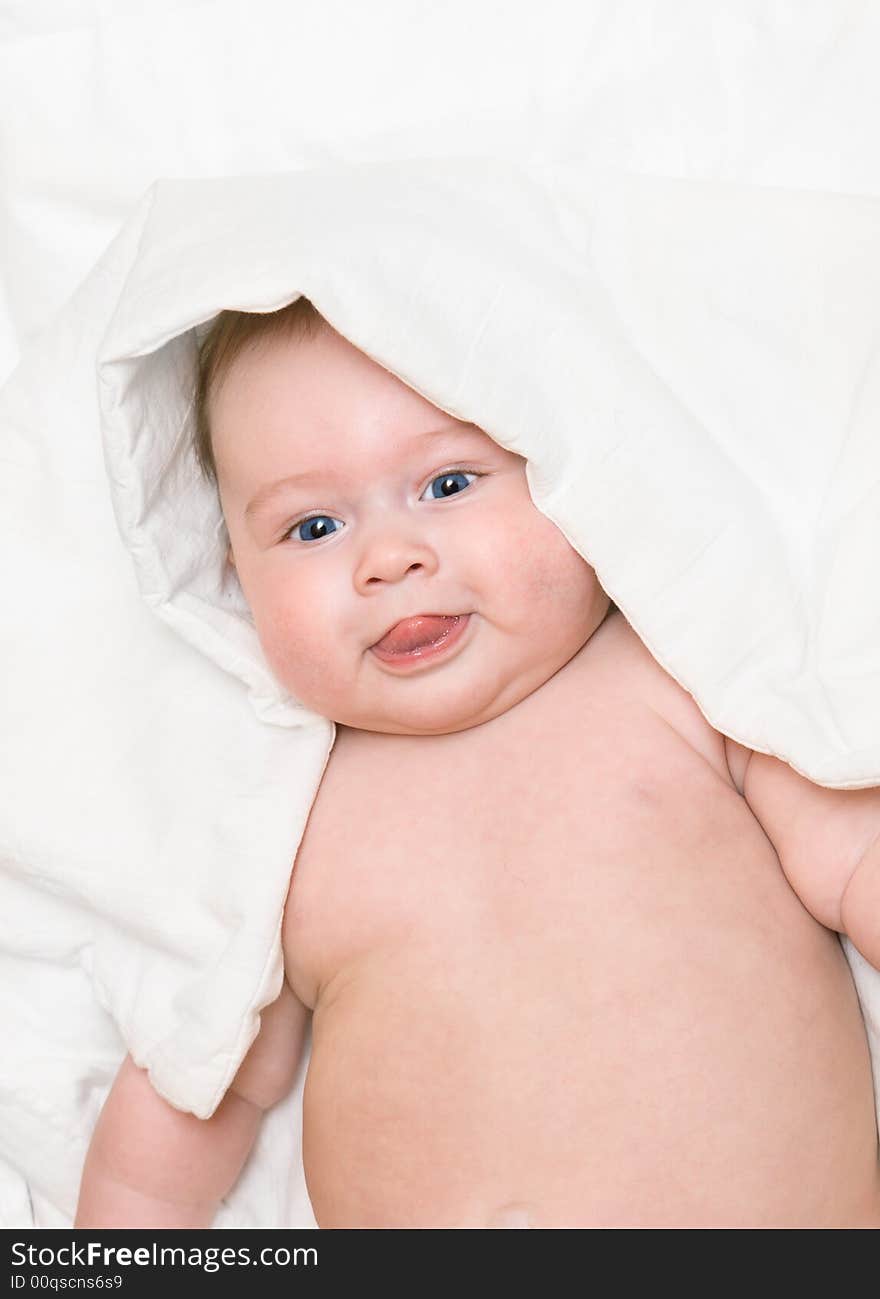 Small smiling baby on bed