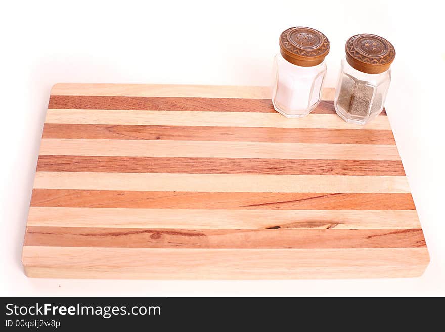 Kitchen board with pepper pot and salt - copy space