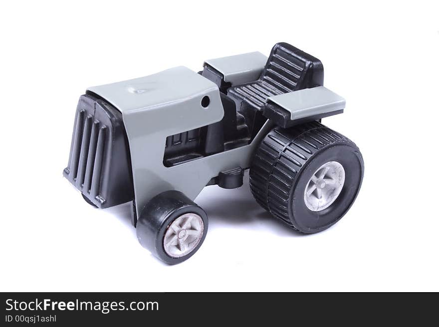 Grey tractor toy on the white background. Grey tractor toy on the white background