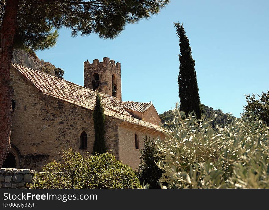 Village church immersed in the green of the trees