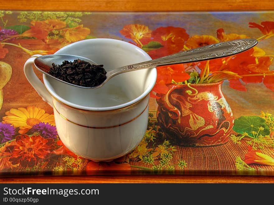 The Spoon of granulated tea with white cup on bright red background. The Spoon of granulated tea with white cup on bright red background.