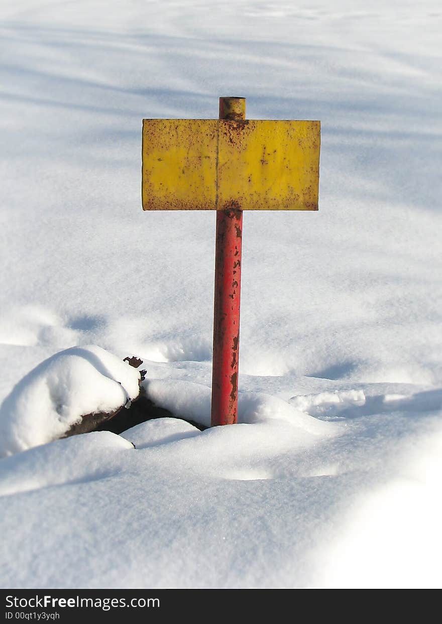 Old yellow rusty tablet on white snow background