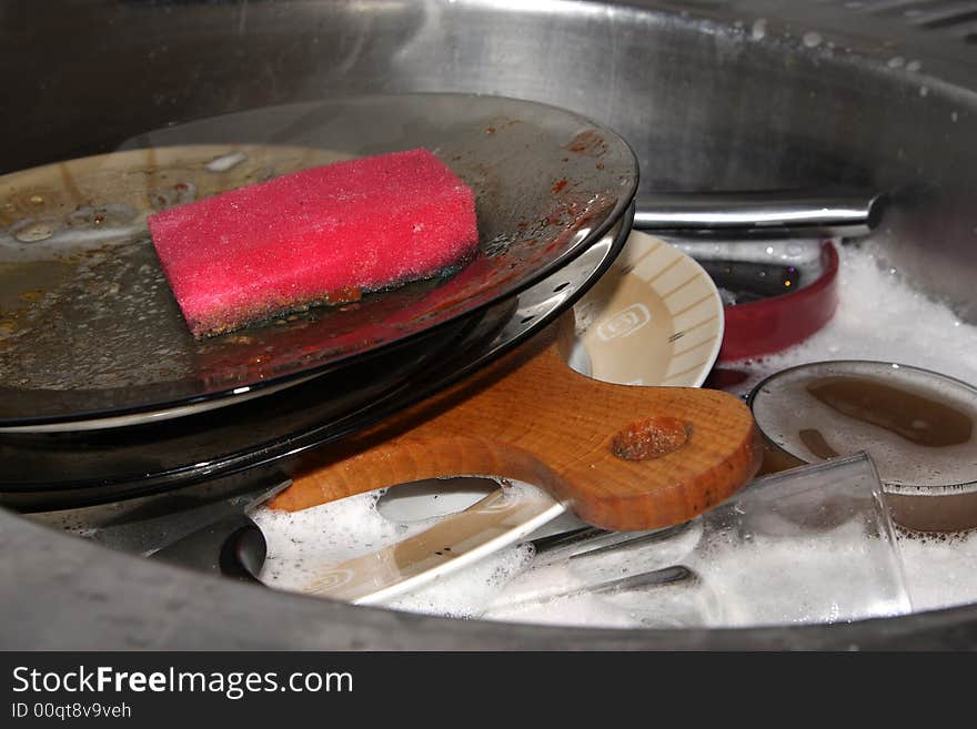 Washing dirty plates in kitchen. Washing dirty plates in kitchen