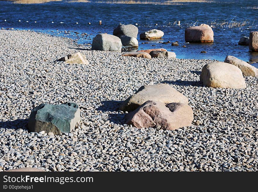 Stone on the winter lake shore