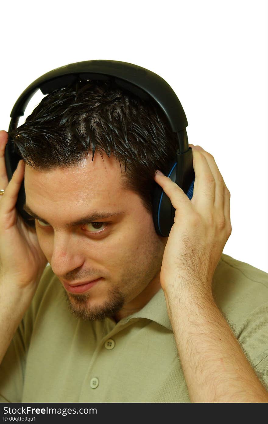 A man, wearing headphones, listening to some music. A man, wearing headphones, listening to some music