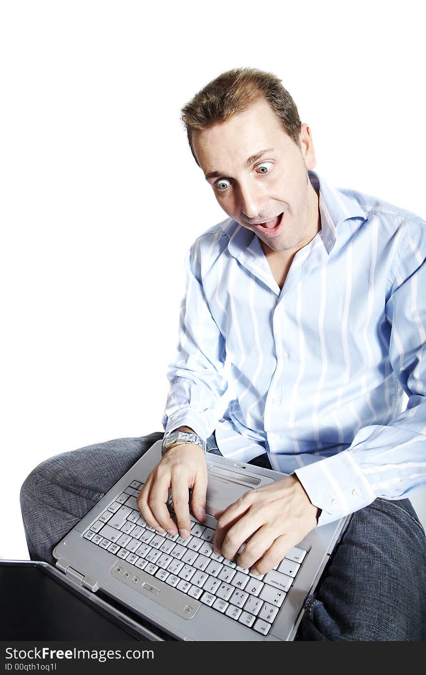 Man with surprised face using a laptop computer. Isolation on white.