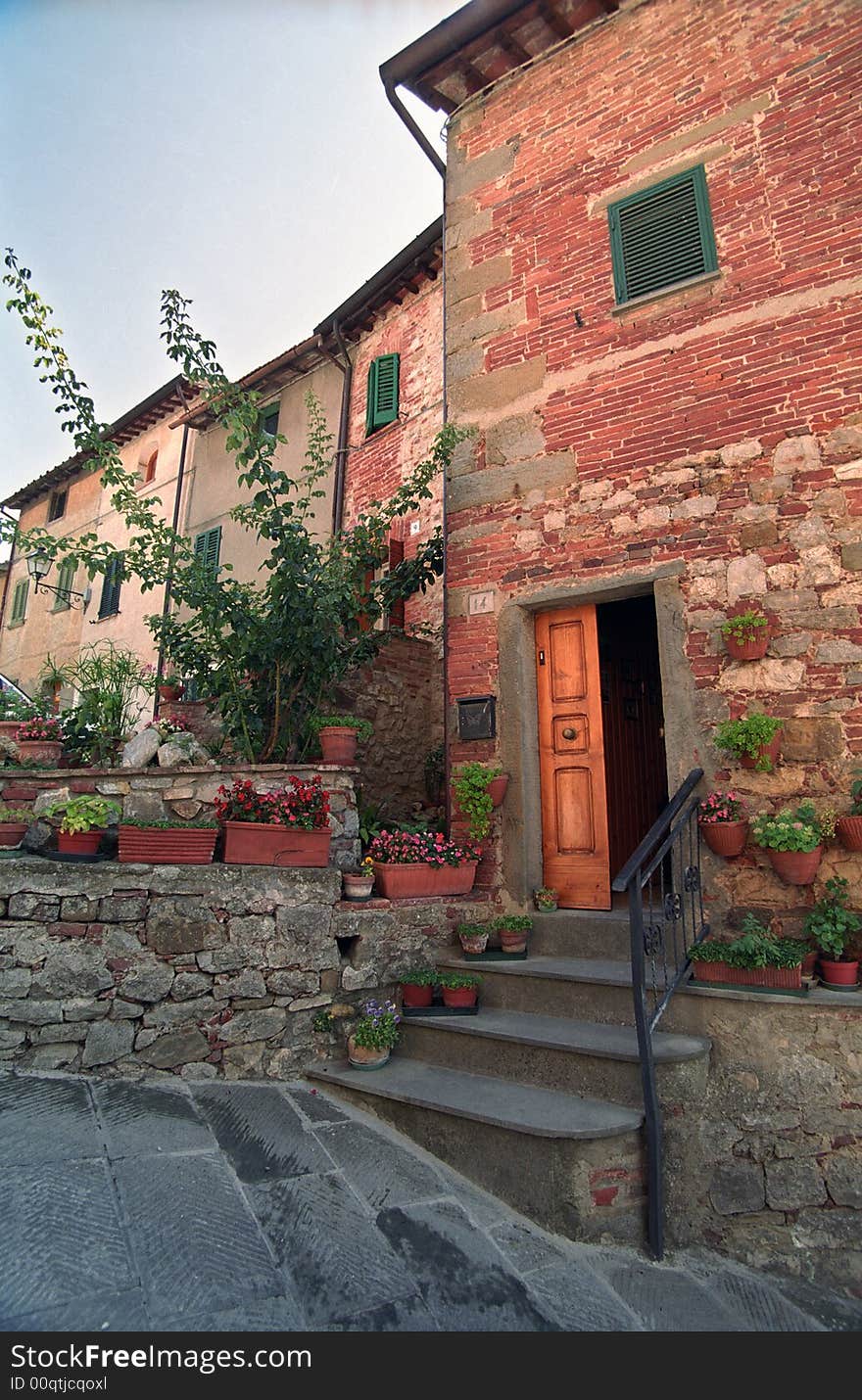 Open door in Italy with stairs and flowers