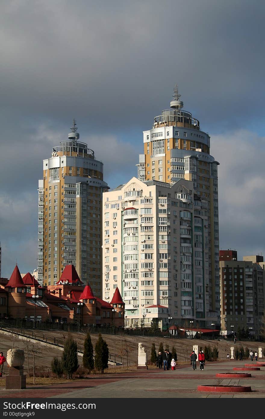 Yellow and pink urban tall buildings under cloudy sky. Yellow and pink urban tall buildings under cloudy sky