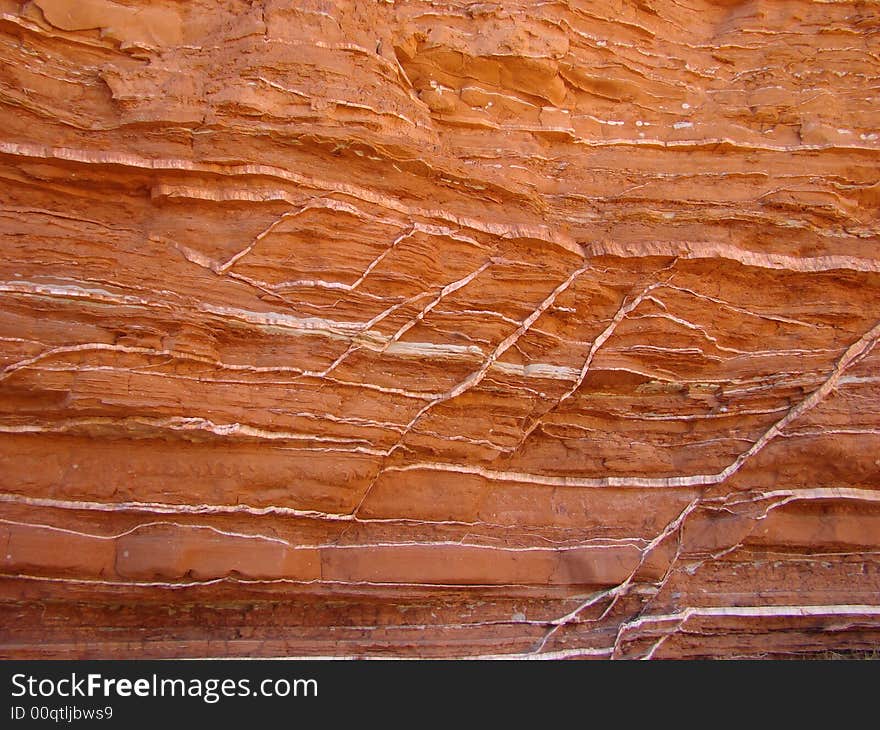 Red canyon wall with streaks of white gypsum. Red canyon wall with streaks of white gypsum.