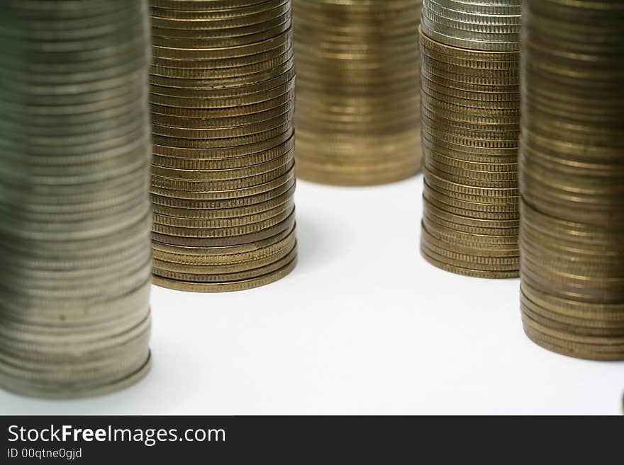 Close-up of multicolor coins stacks on the white background (isolated on white)