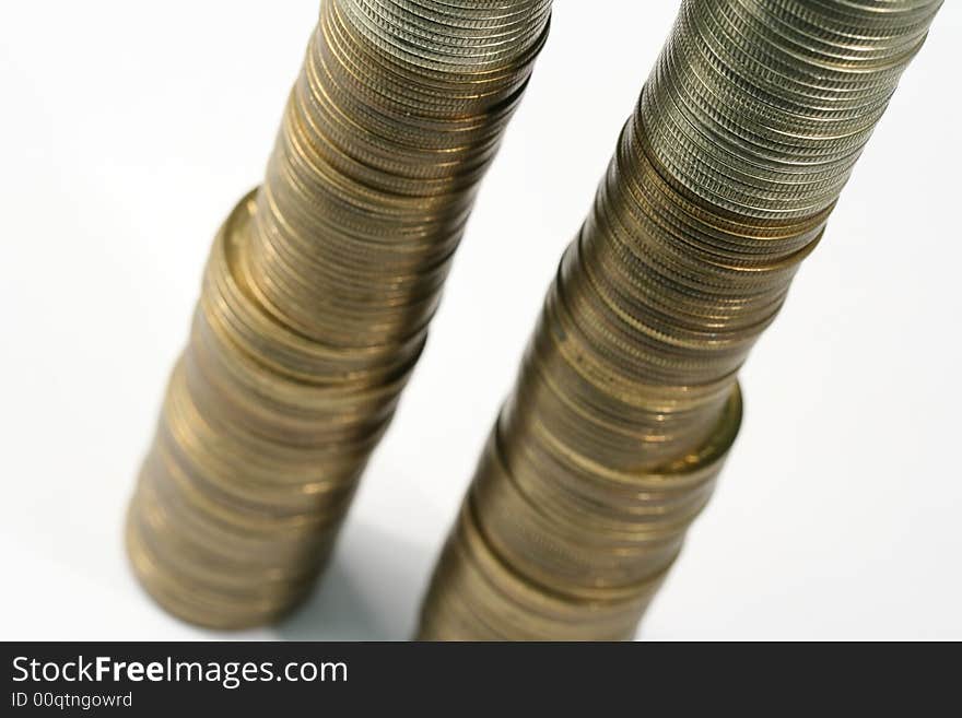 Close-up of multicolor coins stacks on the white background (isolated on white)