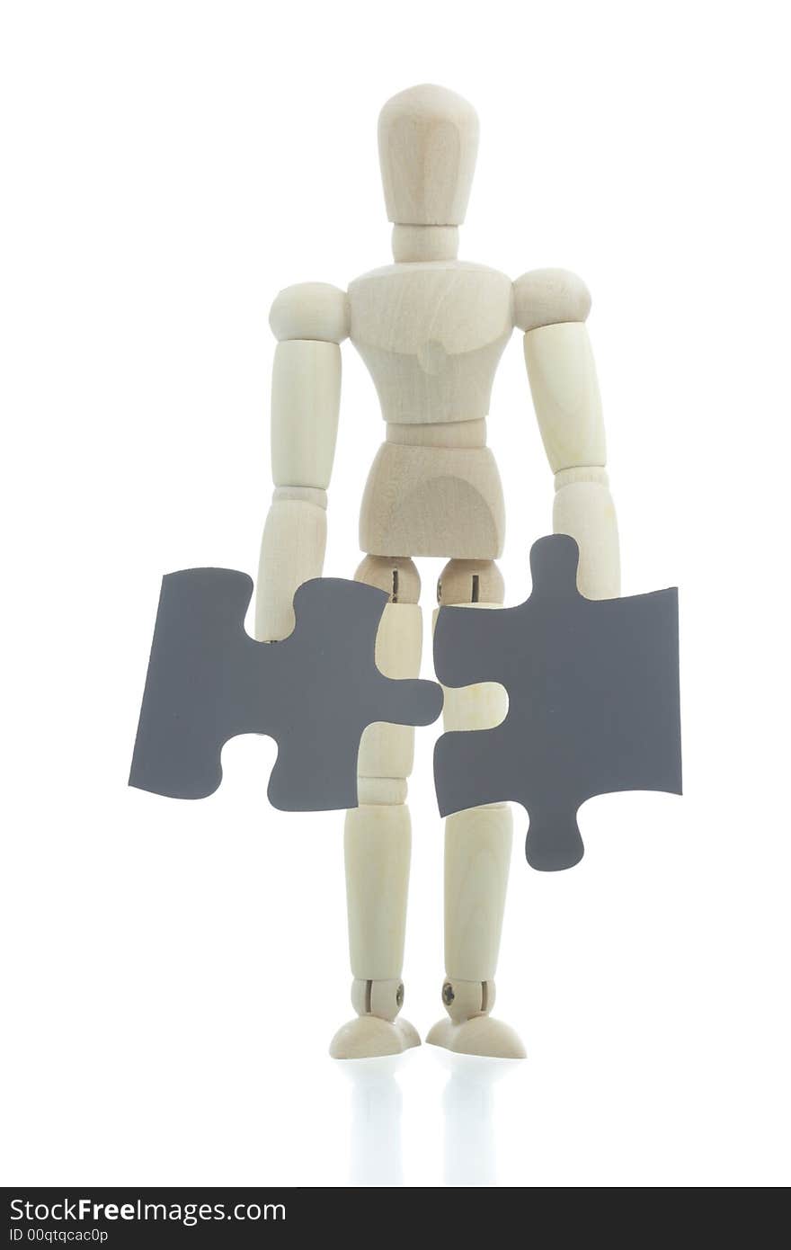 Manikin holds black puzzle pieces. Manikin holds black puzzle pieces