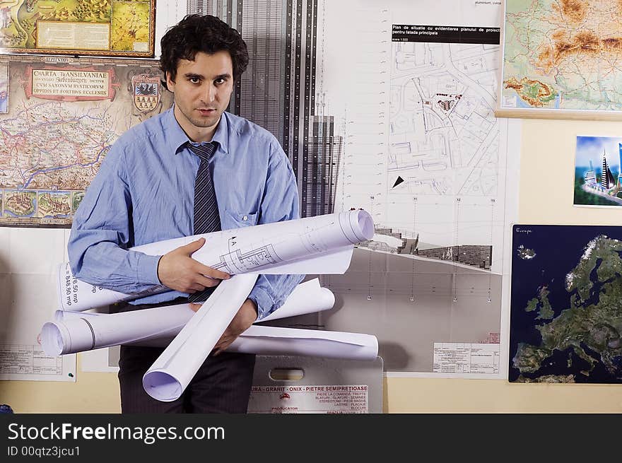 Arhitect man with papers at office