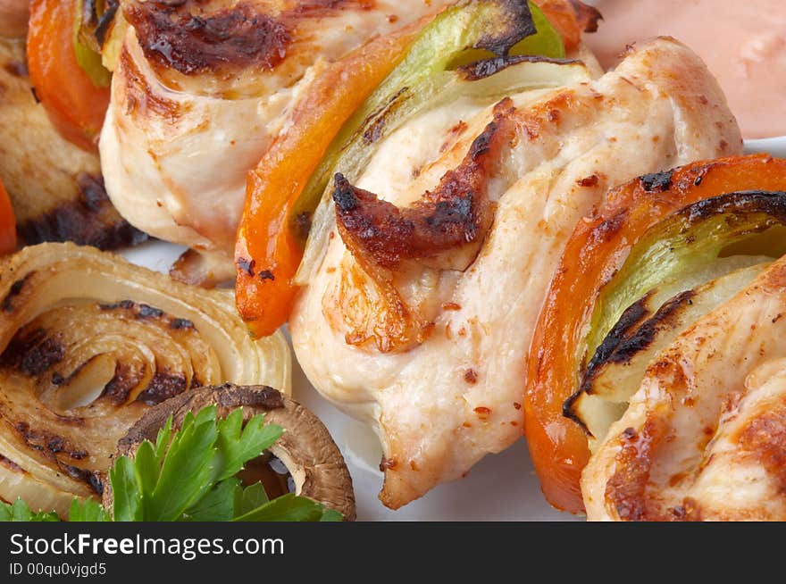 Kebab served with grilled vegetables on white plate, selective focus. Kebab served with grilled vegetables on white plate, selective focus