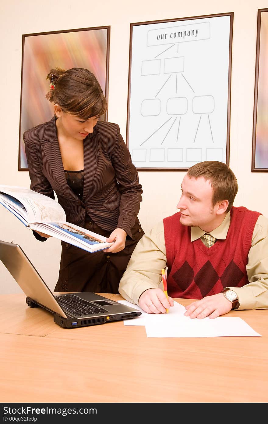 Businesswoman showing papers to her boss. Businesswoman showing papers to her boss