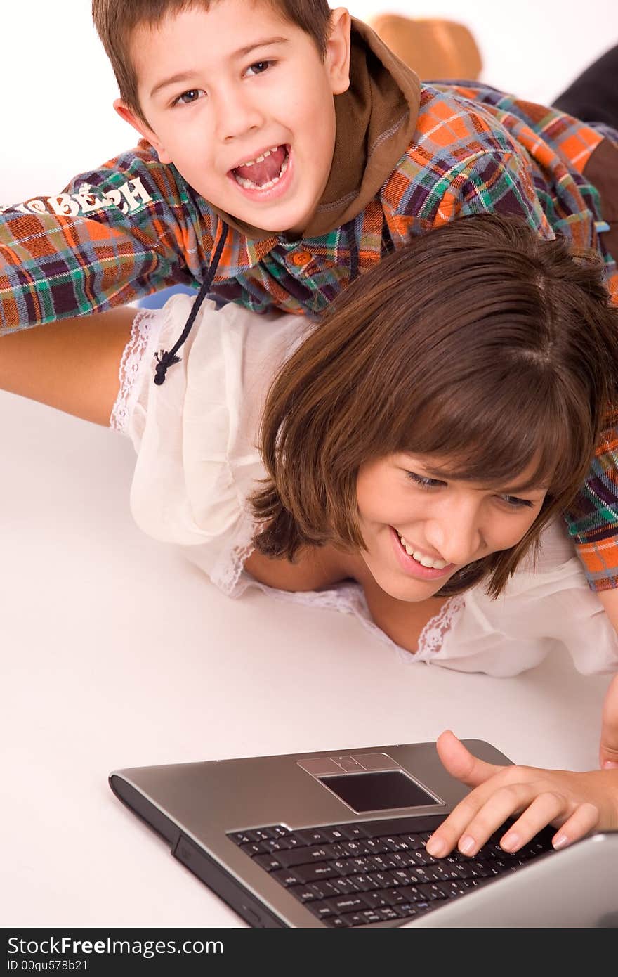 Mother and son playing with laptop over white background. Mother and son playing with laptop over white background