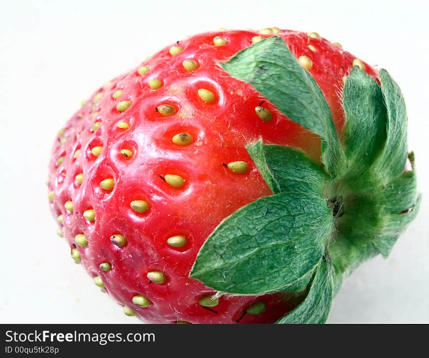 Single strawberry over a bright white background