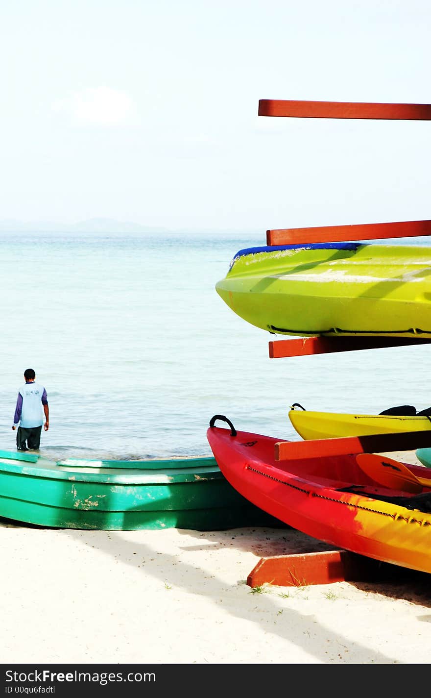 Sea kayaks on the beach - travel and tourism.