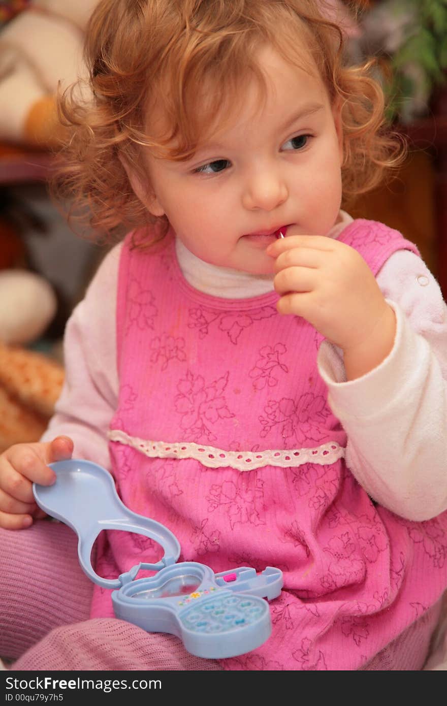 Little girl with toy makeup