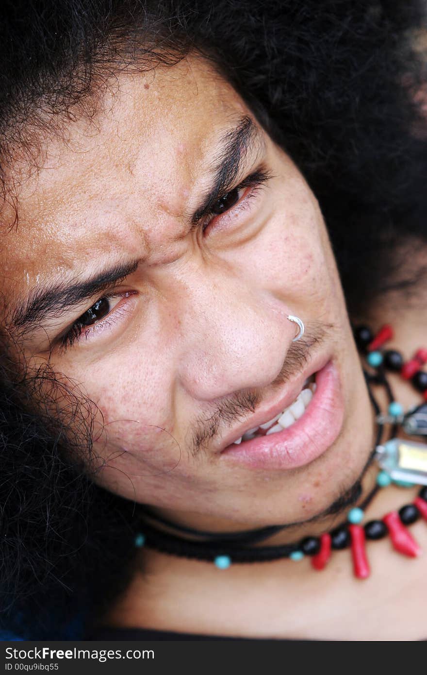 Close-up portrait of a young Thai man.