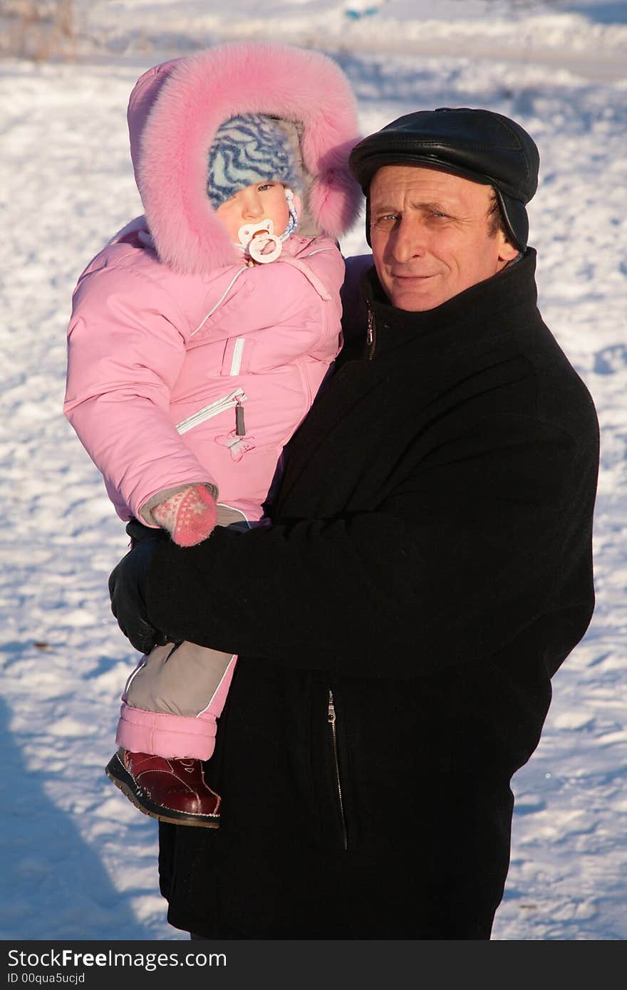 The grandfather and grandchild on hands