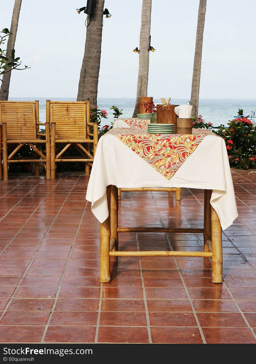 Table setting at a tropical outdoor restaurant.