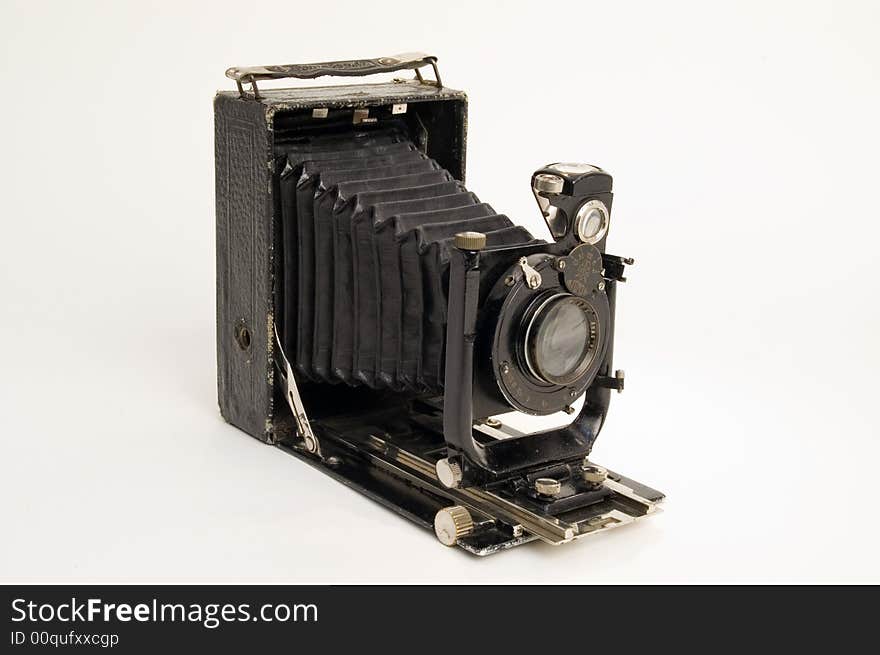 The old photographic chamber with a lens of furs on a white background. The old photographic chamber with a lens of furs on a white background.