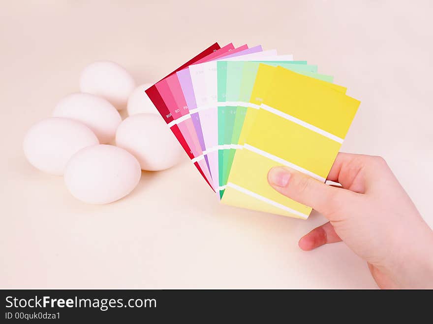 White eggs on the table and palette of colour