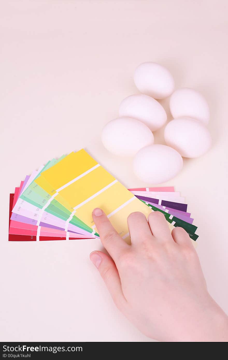 White eggs on the table and palette of colour