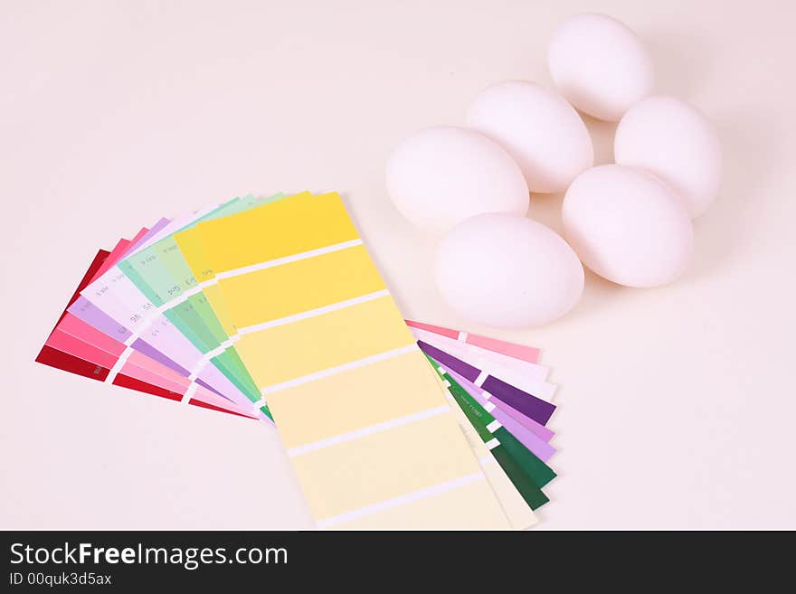 White eggs on the table and palette of colour