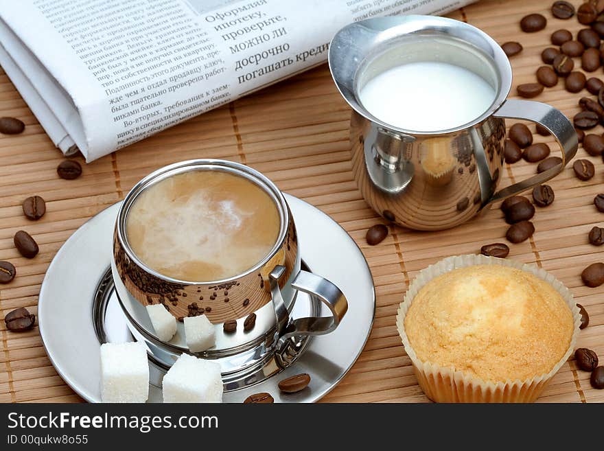 Cup of coffee with muffin and milk