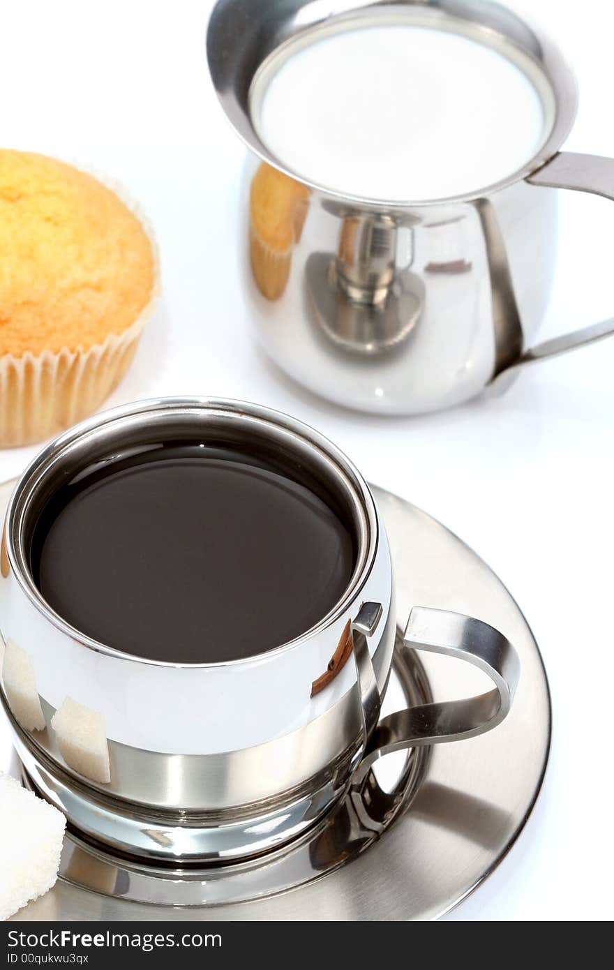 Cup of black coffee with muffin and milk