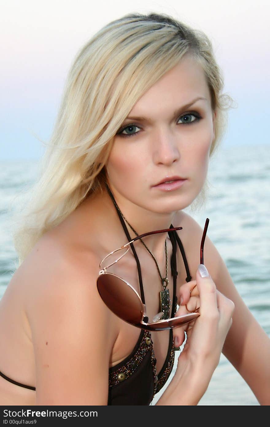 The girl on a beach on a background of the sea