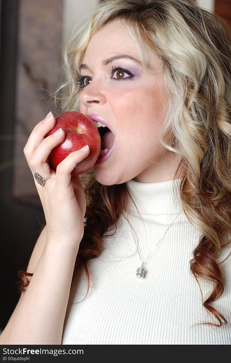 Beautiful woman is holding a fruit in her hands. Beautiful woman is holding a fruit in her hands