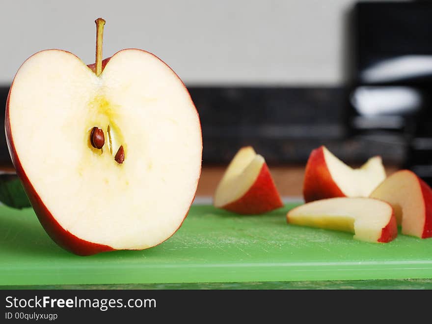 Apple on the counter symbolizes healthy living and nutritional value. Apple on the counter symbolizes healthy living and nutritional value