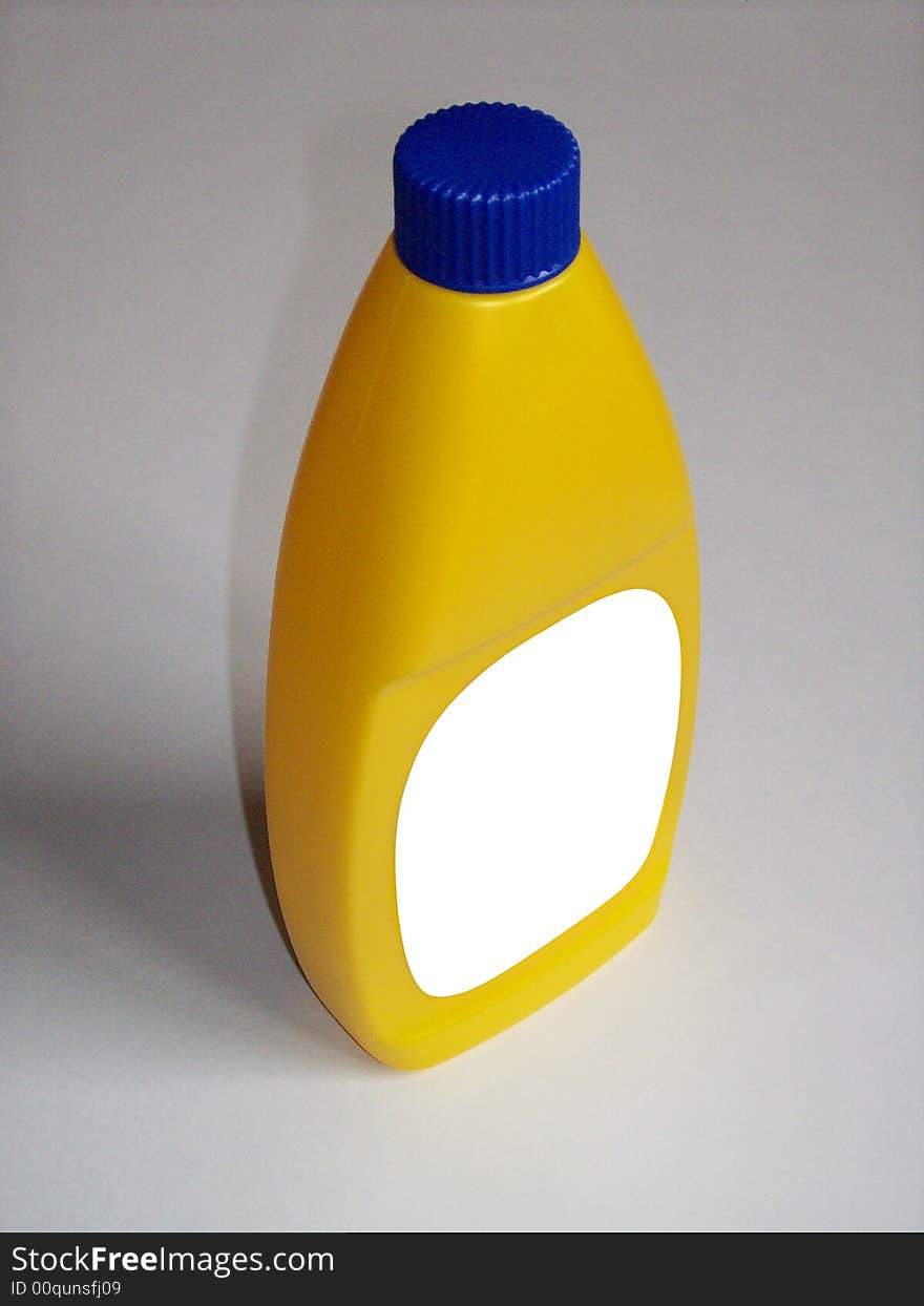 Photo of a yellow plastic bottle with the label blanked out. Photo of a yellow plastic bottle with the label blanked out