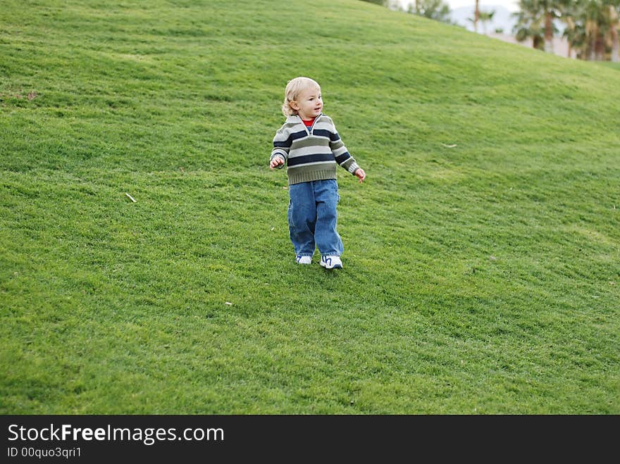 A little kid is enjoying his time in the park. A little kid is enjoying his time in the park