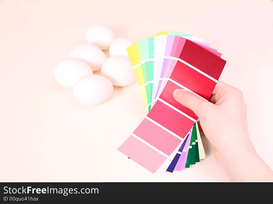 White eggs on the table and palette of colour