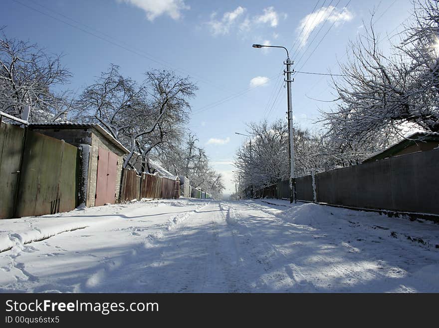 Frozen winter road in the village